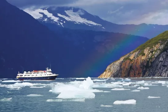 National Geographic Lindblad Expeditions ship near a rainbow in Alaska