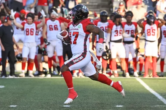 REDBLACKS player running with the football