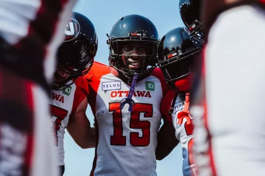 Ottawa REDBLACKS players in the huddle