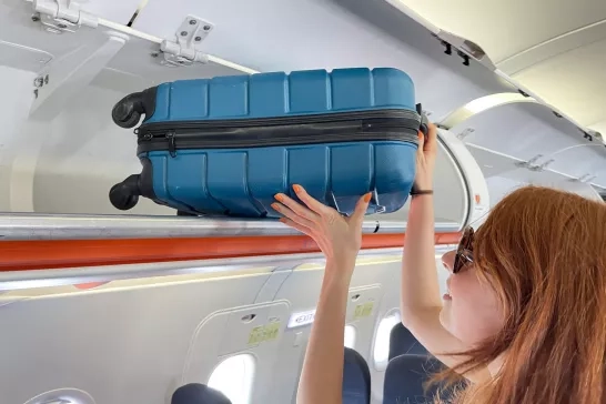 place carry on luggage in overhead bin