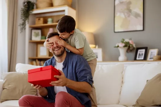 Son Covers His Father's Eyes