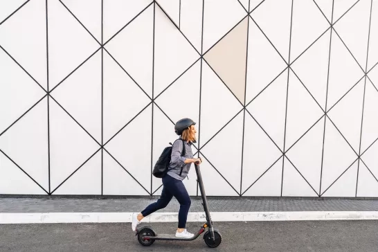  adult woman riding an electric scooter