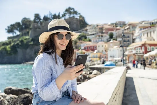 Woman on a summer vacation using her phone.