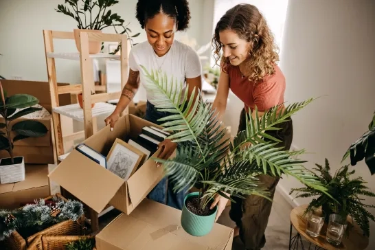 two women unpacking boxes