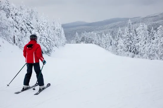 A skier is sliding down an easy slope at Mont-Tremblant.
