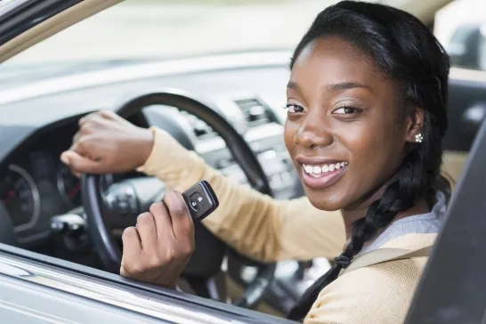 woman in car holding car keys