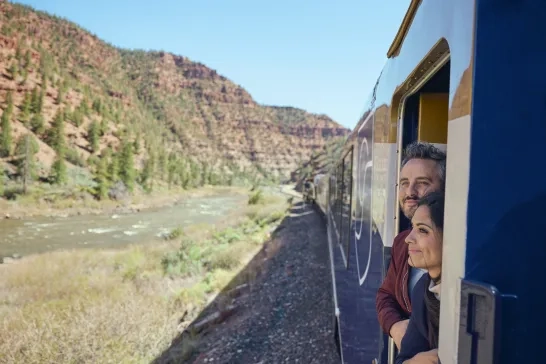 Couple admiring the view outside the train on Canyon Spirit