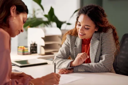 woman signing insurance paperwork