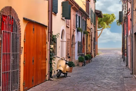 Street with scooter and old houses in Rimini Italy stock photo