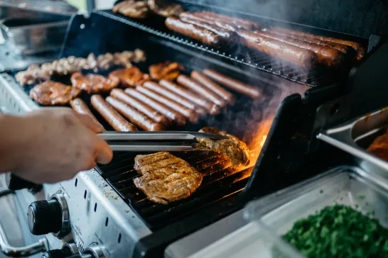 Grilling Meat and Hot Dogs on Gas Barbecue 
