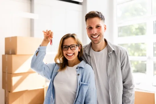 Couple holding keys to their new house