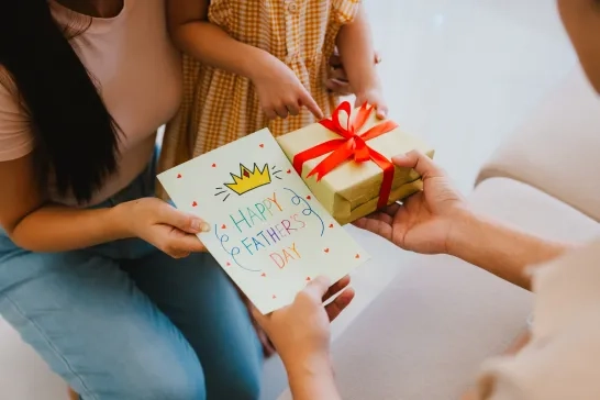 girl giving Father's Day gift to her father