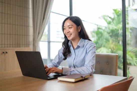 businesswoman working on laptop at desk 