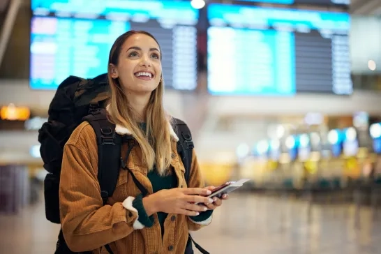 woman holding passport at airport