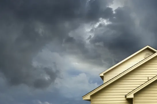 House roof with stormy skies