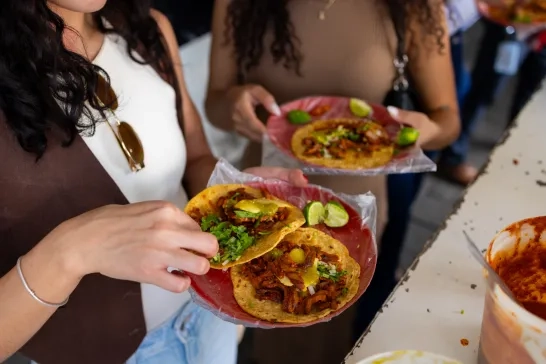 Two women eating tacos