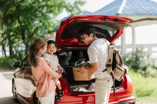 Family loading car for a roadtrip