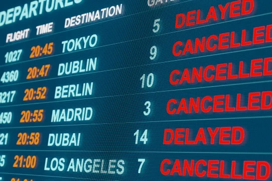 Close up monitor with flight departure board. Flights are cancelled or delayed. 