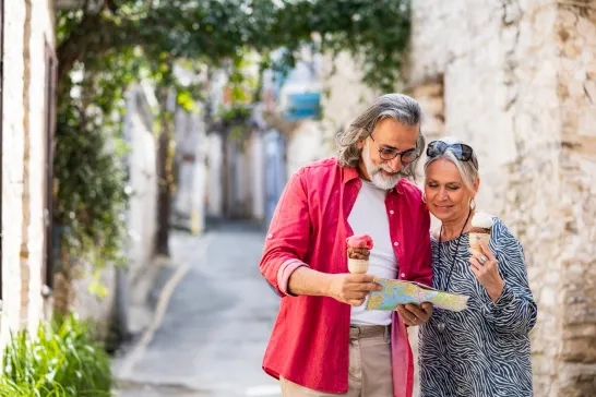 man and woman with map and ice cream in hand