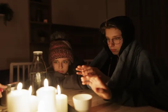 Family sitting by the candles during the blackout