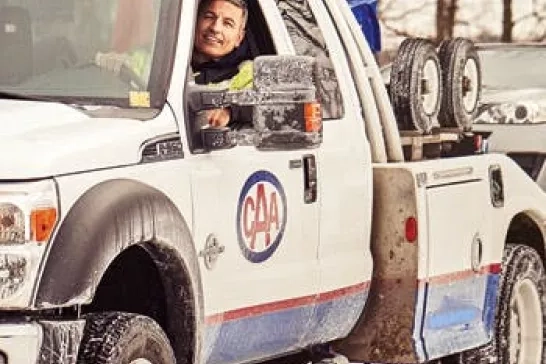 CAA tow truck with smiling driver