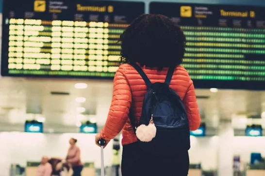 Woman standing at the airport with her luggage Woman standing at the airport with her luggage