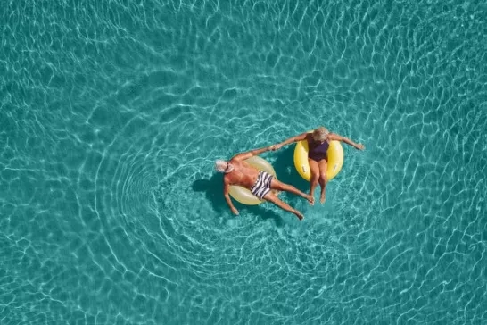 Senior couple floating in the water