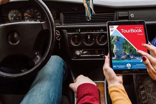 Woman viewing an Ontario TourBook on her tablet 
