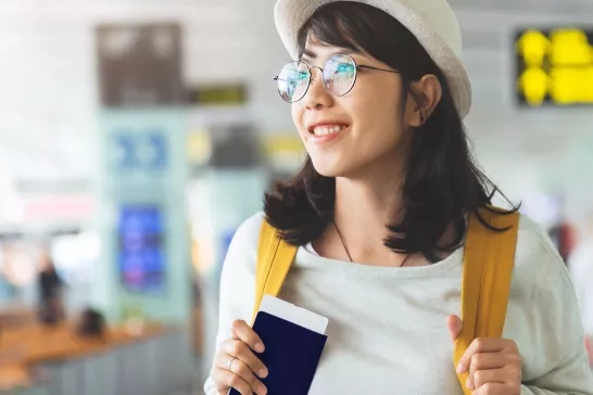 Woman holding passport in an airport