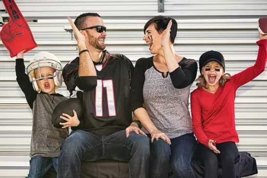 Family watching football game together in stands