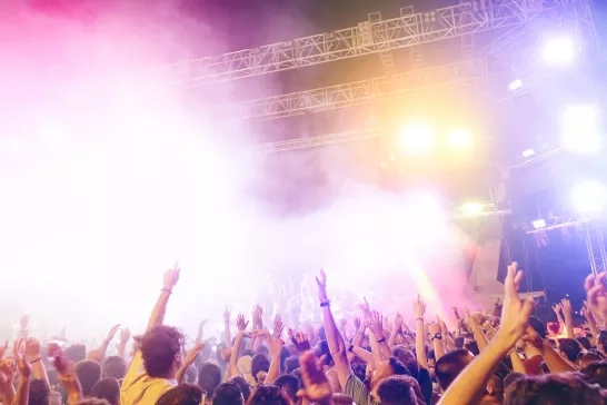 Young people dancing and having fun in summer festival party out