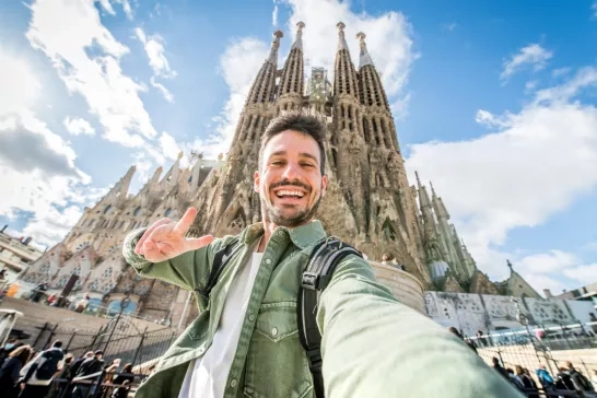 Happy tourist visiting La Sagrada Familia, Barcelona Spain - Smi