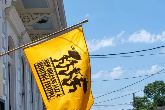 New Orleans Jazz and Heritage Festival Flag hanging from the front of a historic home in the Bywater Neighborhood on May 7, 2022 in New Orleans, LA, USA