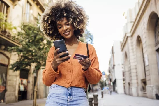 Women in Barcelona shopping online on the move