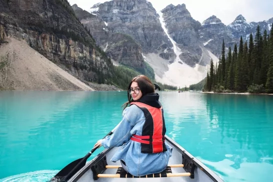 Young girl looking back over shoulder while riding in canoe