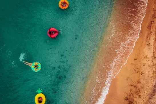 friends having fun on floaties in water