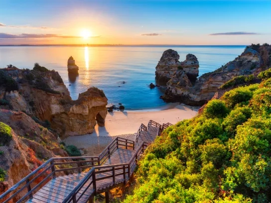 A staircase heading to the beach at sunset in the Algarve Coast, Portugal. 