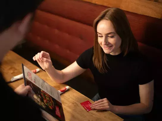 CAA Member dining out at a restaurant using their CAA card to save