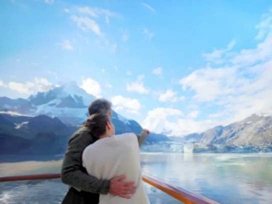 Couple onboard Holland America Line Alaska cruise looking at the horizon
