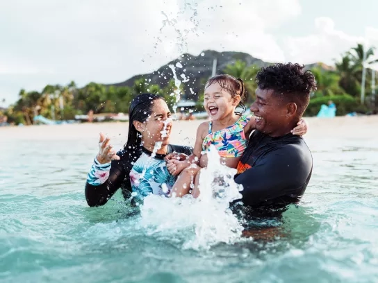 Family playing in the water on vacation