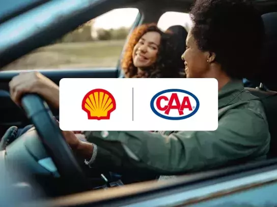 2 women driving in car with Shell CAA logo