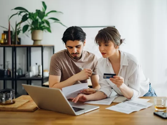 Couple reviewing financial documents together at home