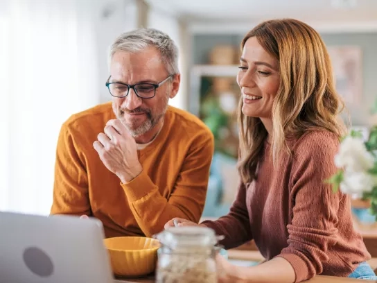 Mature couple enjoying a breakfast video call with family