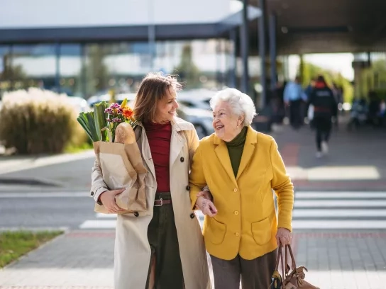 Mature daughter helping grandmother with grocery shopping