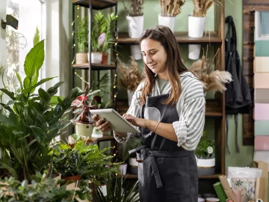 Self-employed lady taking inventory in flower shop