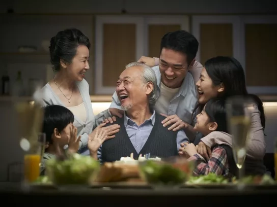 Three generation family celebrating with grandpa at home