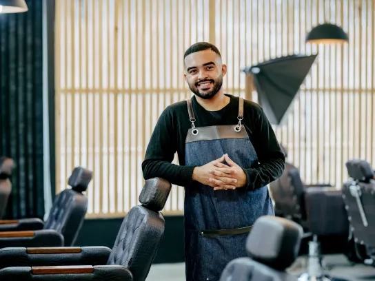 Portrait of a confident young male hairdressers in barbershop