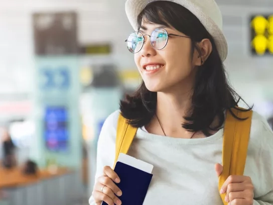 Woman holding passport in an airport