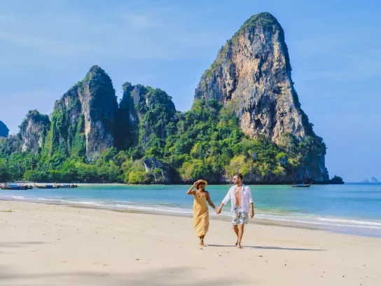 couple of men and woman relaxing on the beach during vacation in Thailand Railay Beach Krabi