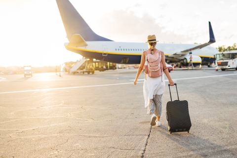 traveler on airport tarmac boarding plane
